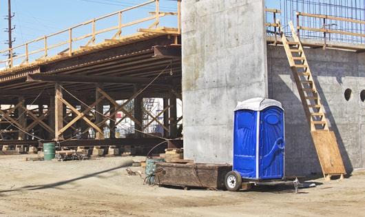 several portable bathrooms positioned at a construction area for convenient employee use